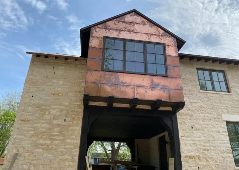 Copper metal panel facade on a stone building for Metal Roof Coating in North Aurora