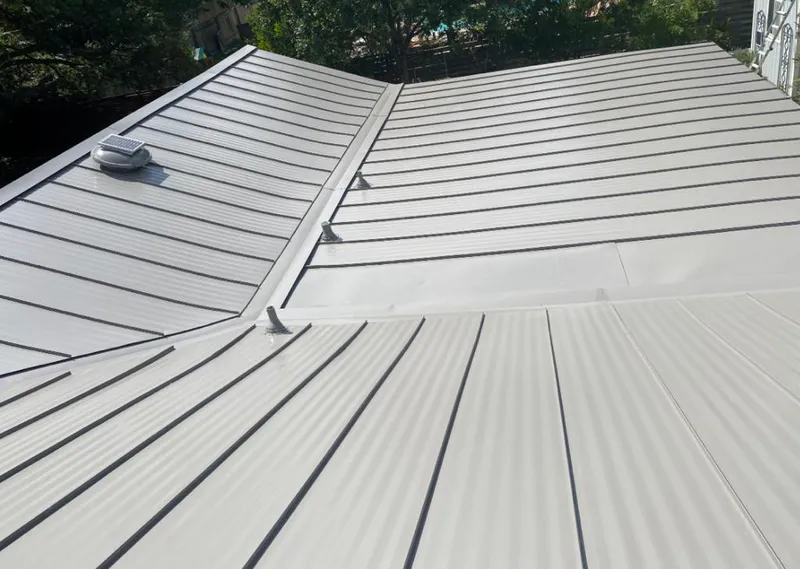 Solar attic fan installed on a metal roof for Roof Ventilation in North Aurora